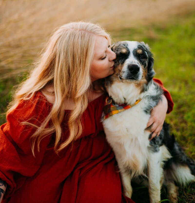 Woman snuggling with dog