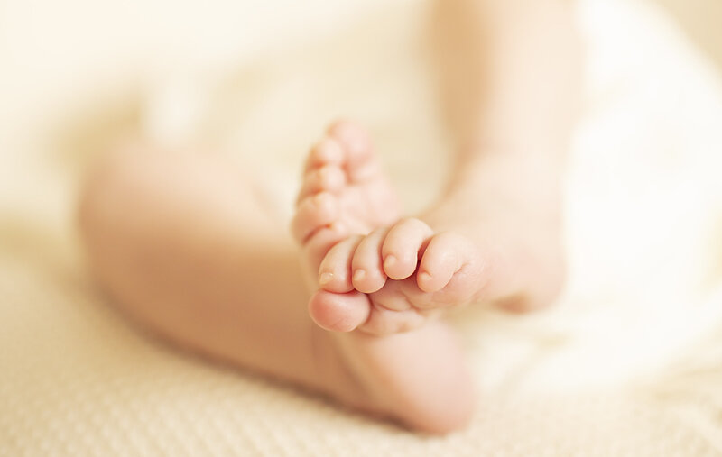 A close up of a newborn babies toes