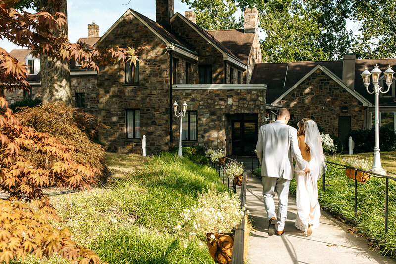 newlyweds walking into reception space