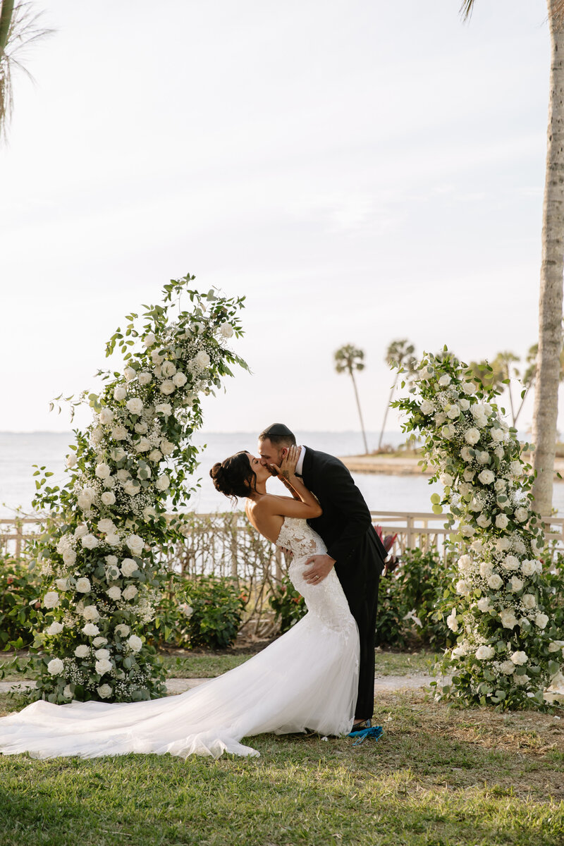kissing bride and groom at ritz carlton sarasota coordinated by Day of Details