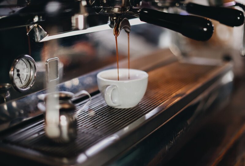 Espresso coming out of machine into cup