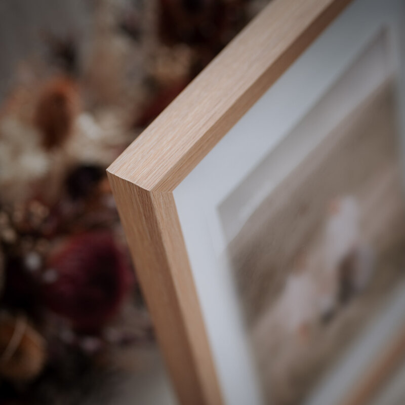 Close up of Oak framed family photo corner