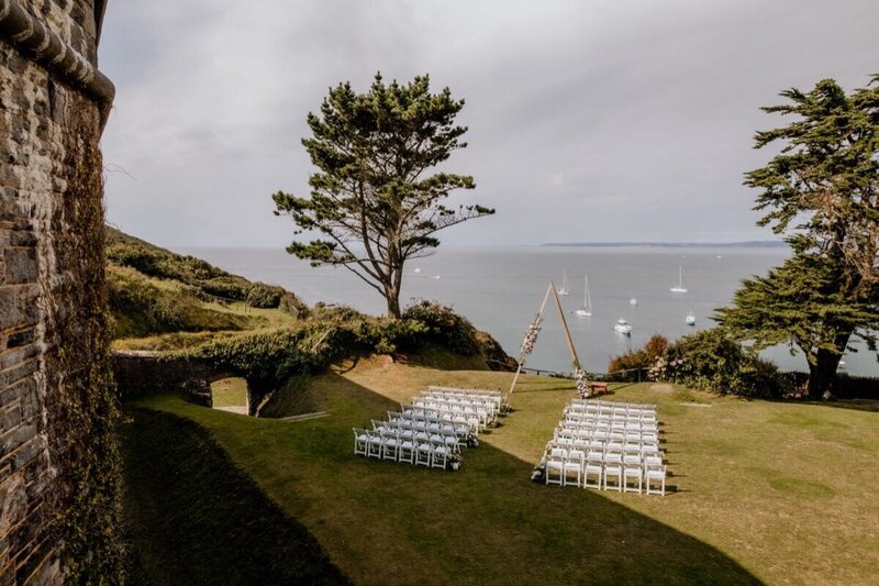 A wedding ceremony setup in front of the fort with views of the sea