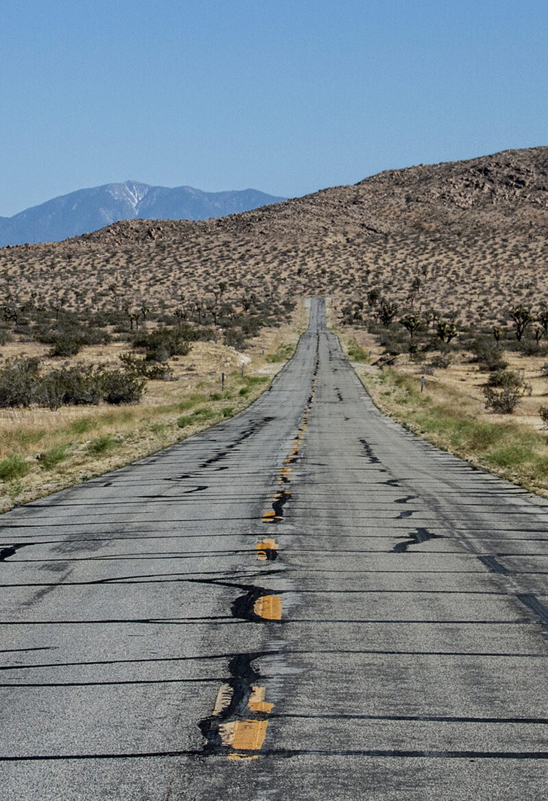 company branding image weathered open road leading to desert hills