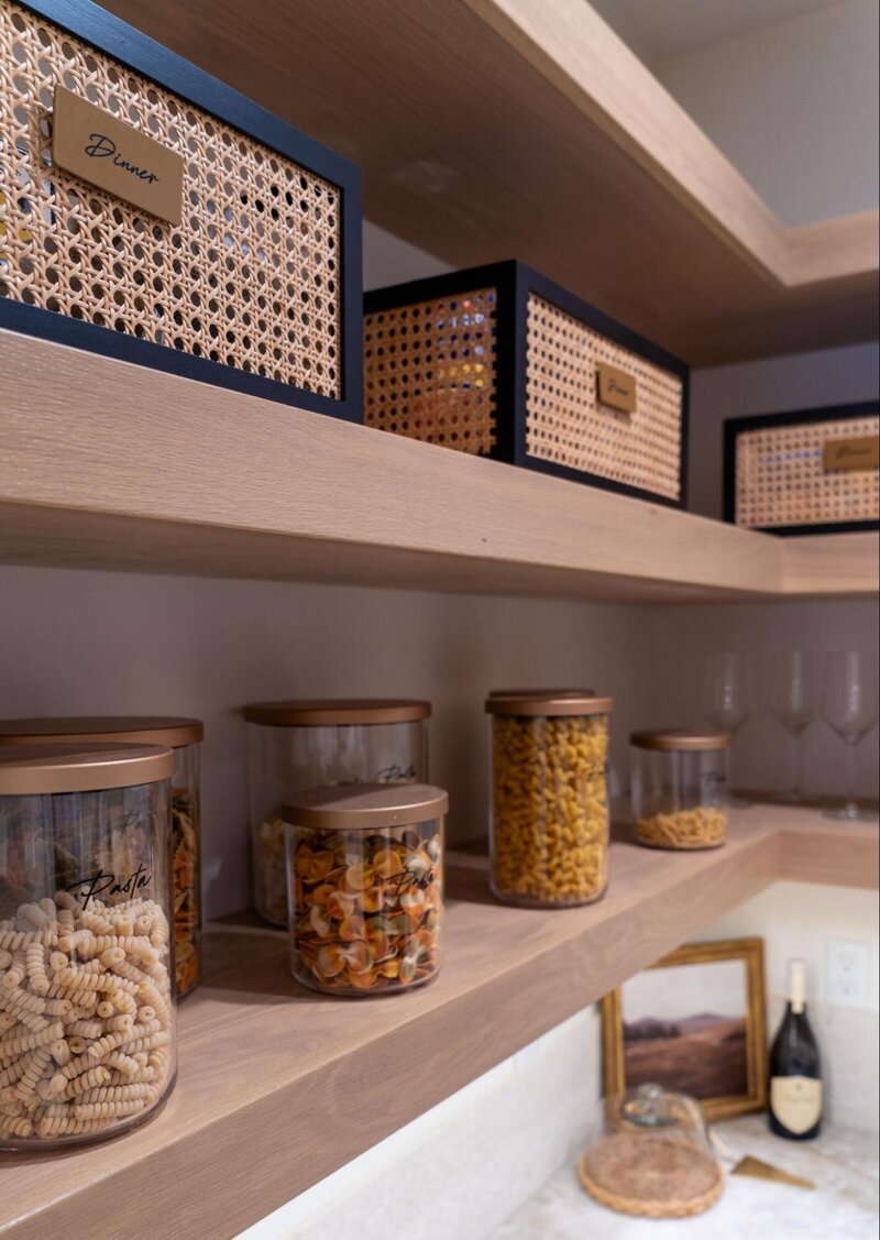 shelving in bathroom with iron candle holders and wood framed art work