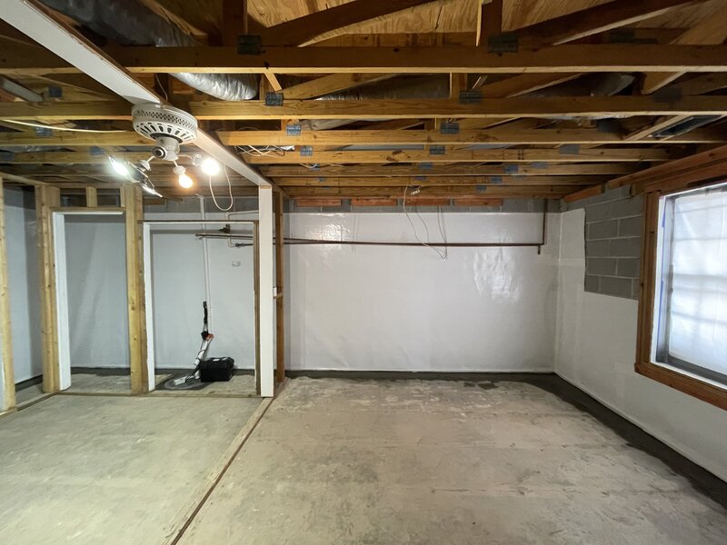 Completed basement waterproofing by APS Waterproofing in Atlanta, showcasing a clean, moisture-protected space with sealed walls.