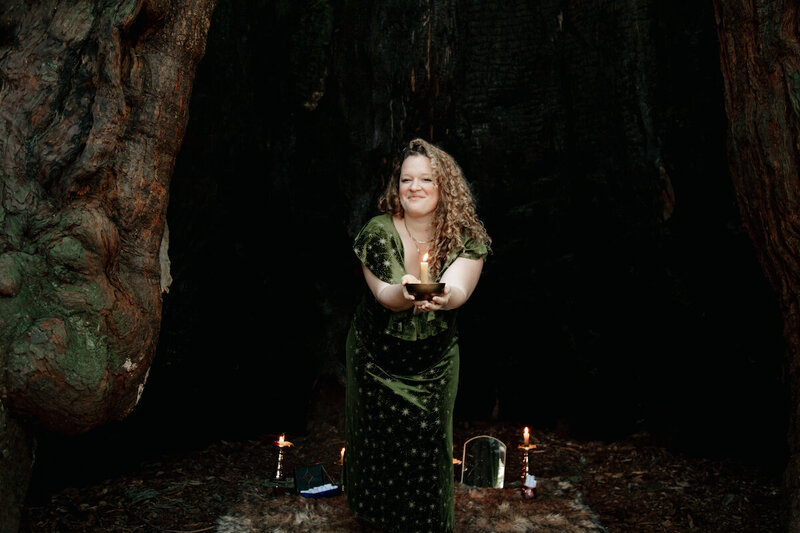 Oracle Business Witch and witchy entrepreneur Rachael Maddox holding a candle, embodying business magick and rituals for spiritual entrepreneurs to make great money.