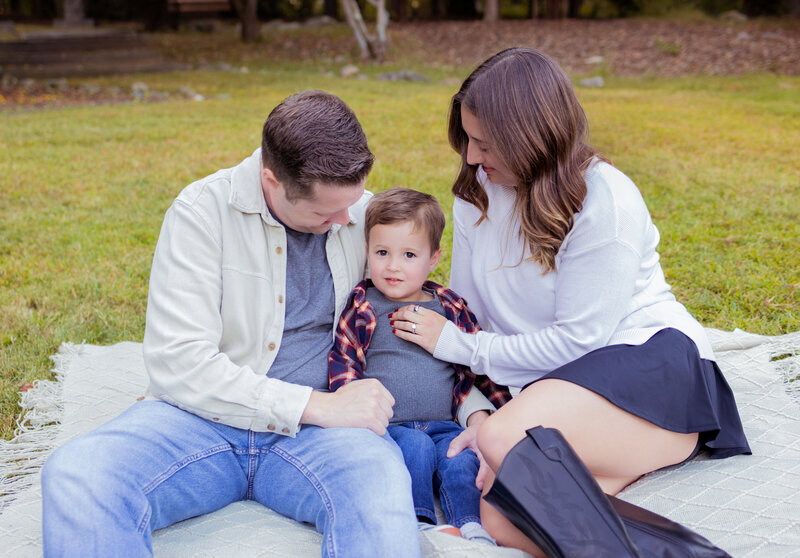 Candid family portrait with parents and child together during a family session near Clifton, NJ