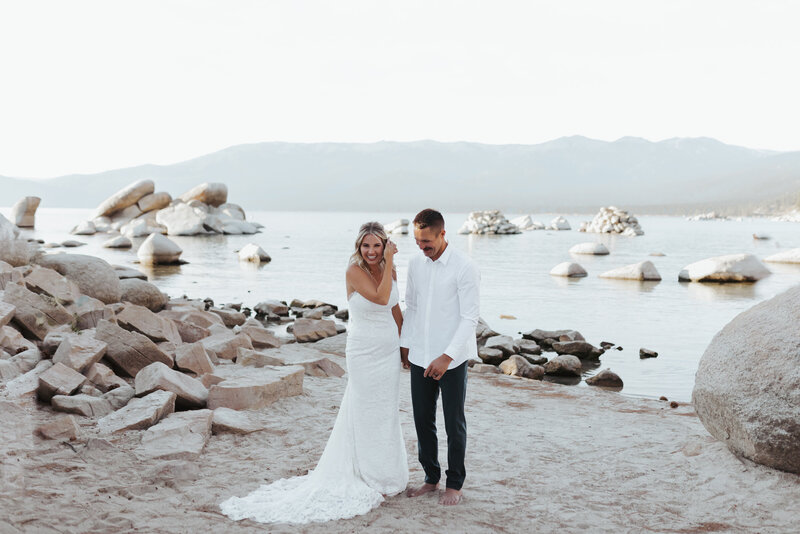 bride and groom walking on beach