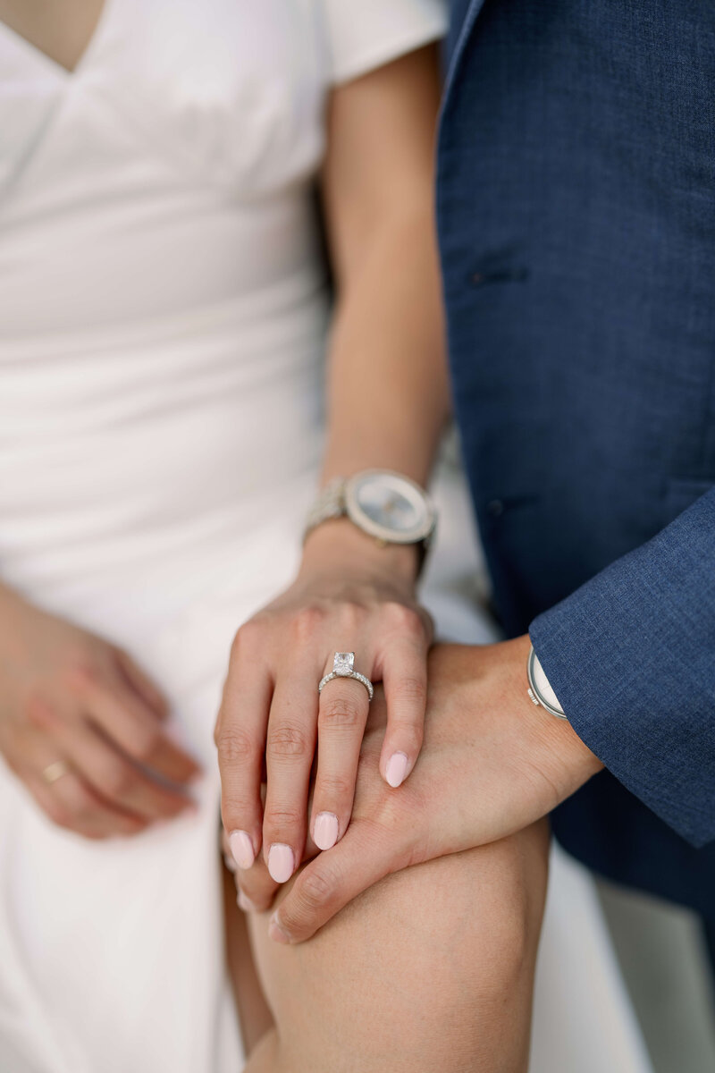 image of a couples hands featuring a silver diamond engagement ring