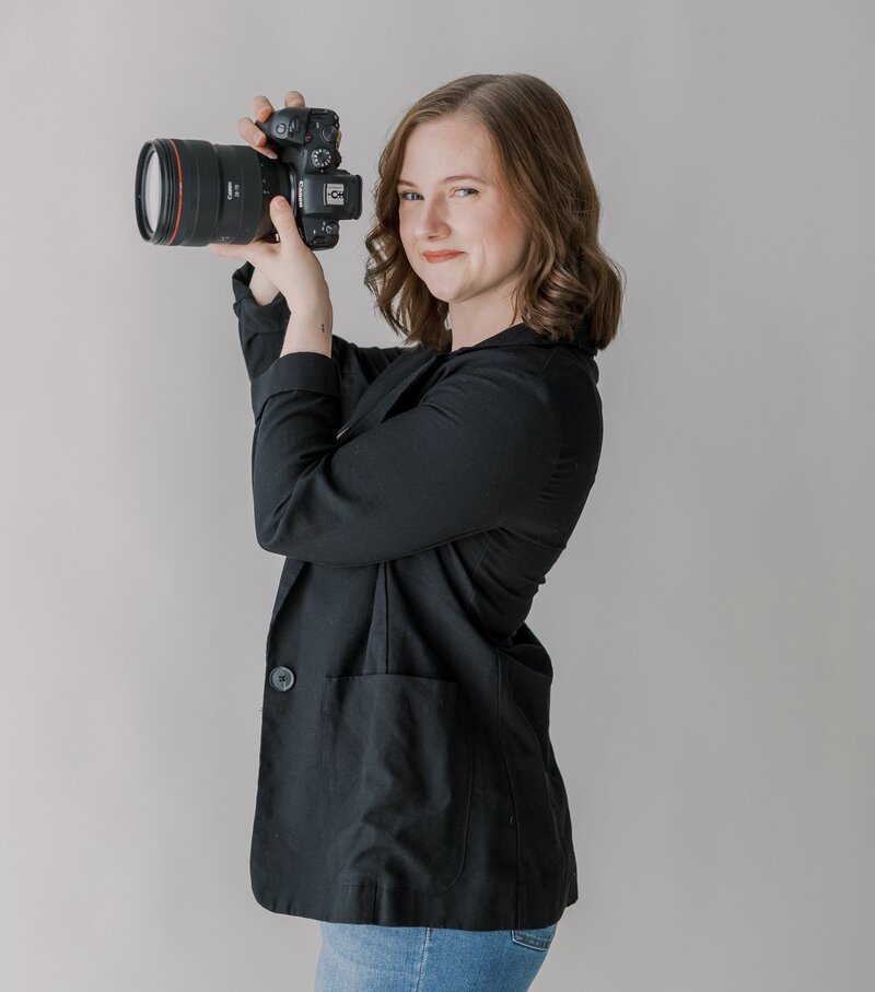 A Richmond family photographer smiles at the camera during her headshots.
