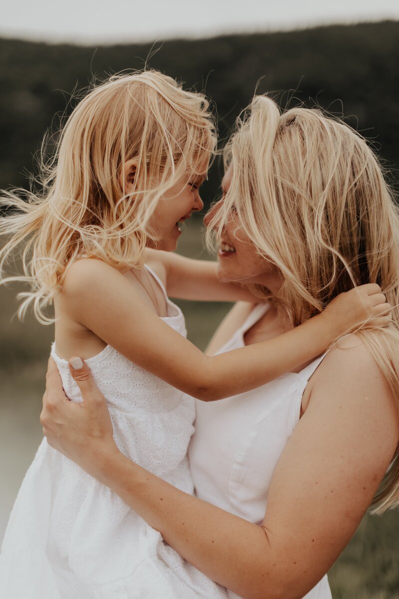 Mom hugging daughter