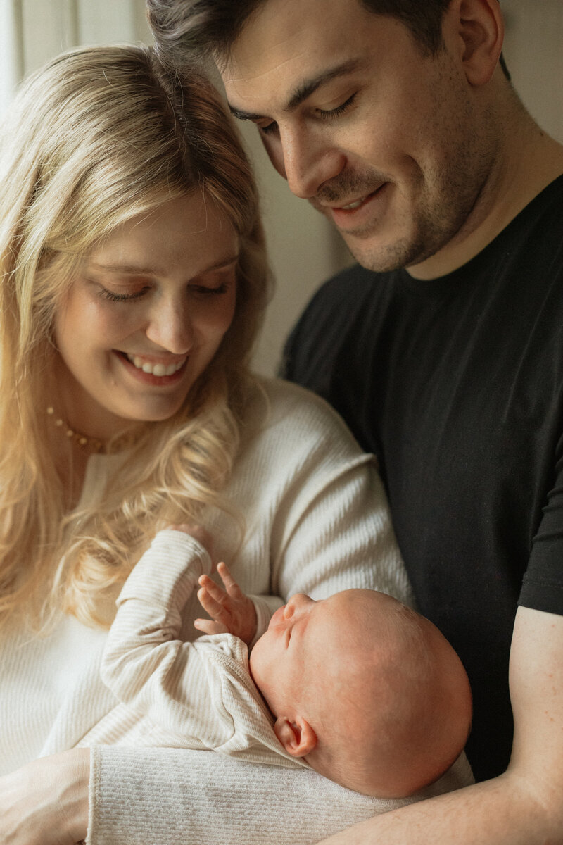 Parents holding newborn baby