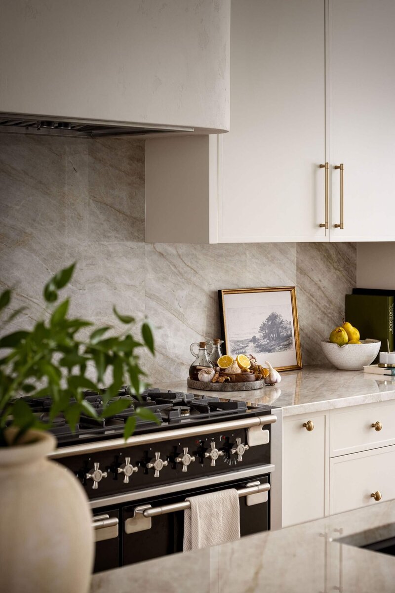 Streamlined kitchen showcasing rich wood cabinetry, tonal stonework, and integrated appliances for a seamless, modern look.