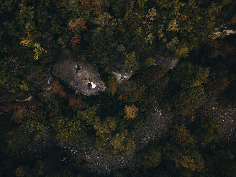 Couple lays on Skinners Bluff for their elopement portraits in Ontario. 