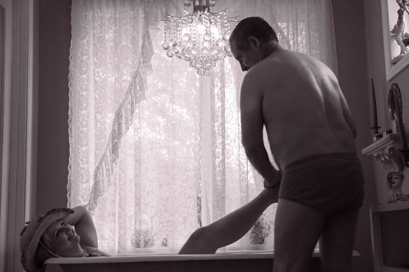 couples boudoir bathtub cowgirl hat rub her feet