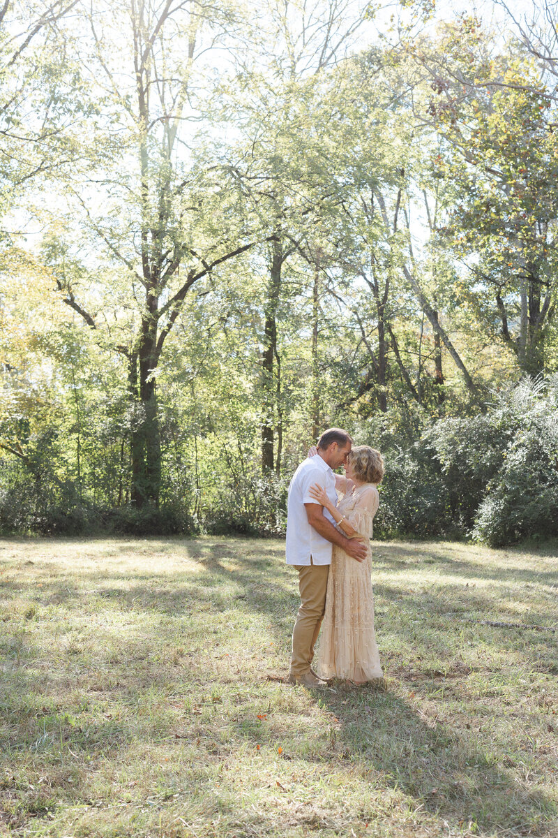 engaged couple touching foreheads and hugging each other in Chattanooga