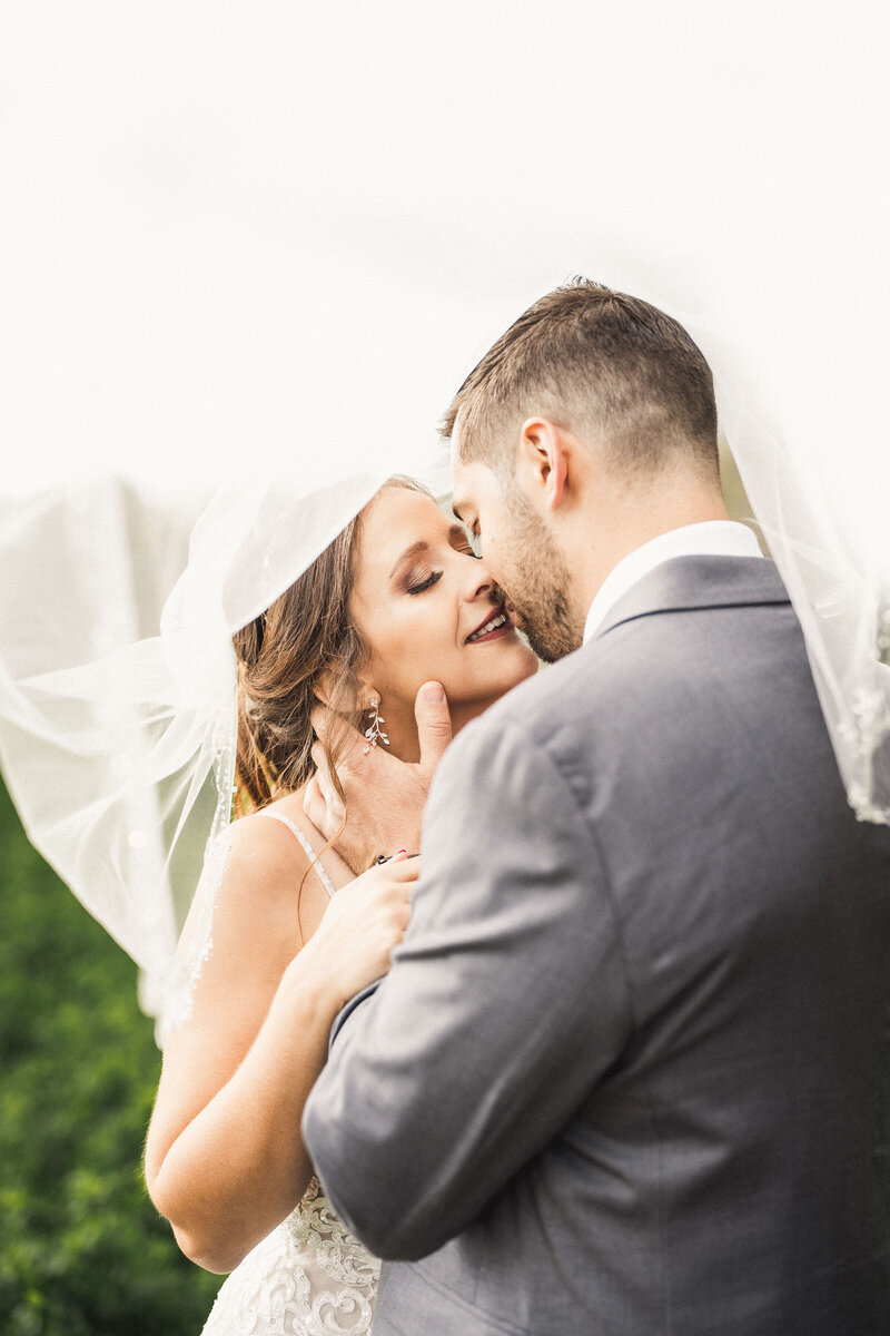 bride and groom under birdes veil