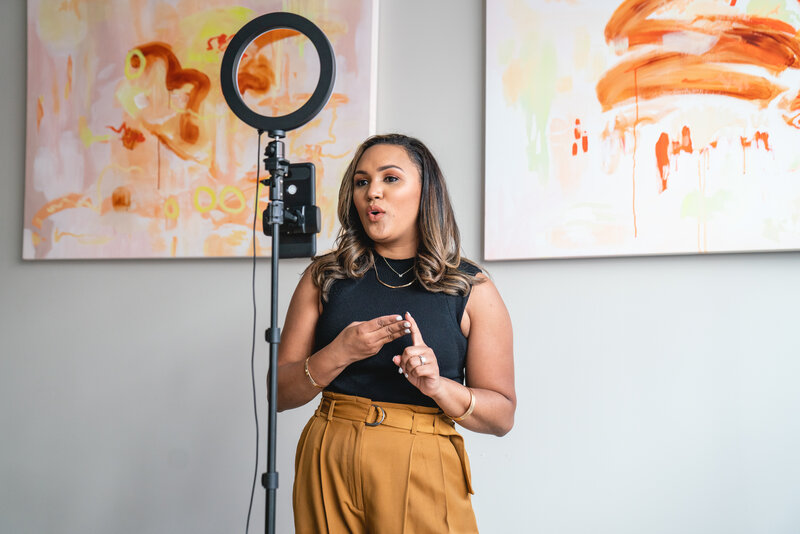 Rossalvi speaking to her clients in her office