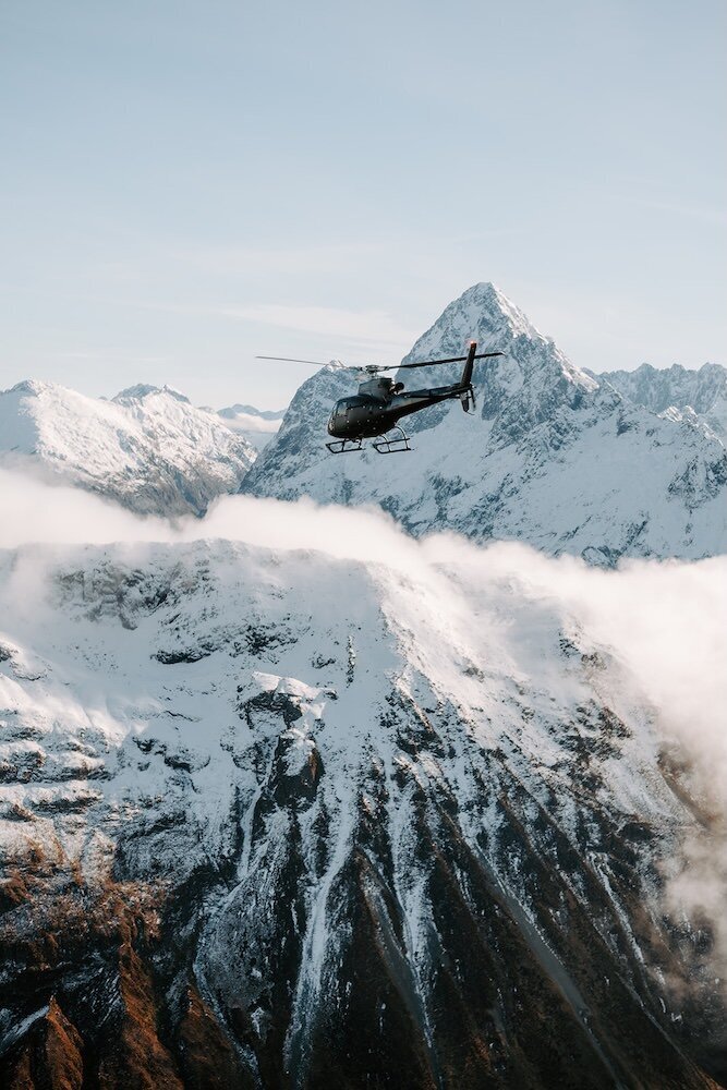 Helicopter flying through New Zealand mountains around Queenstown