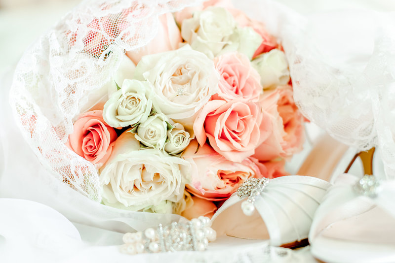 Pink, peach, and white flowers and bride's shoes