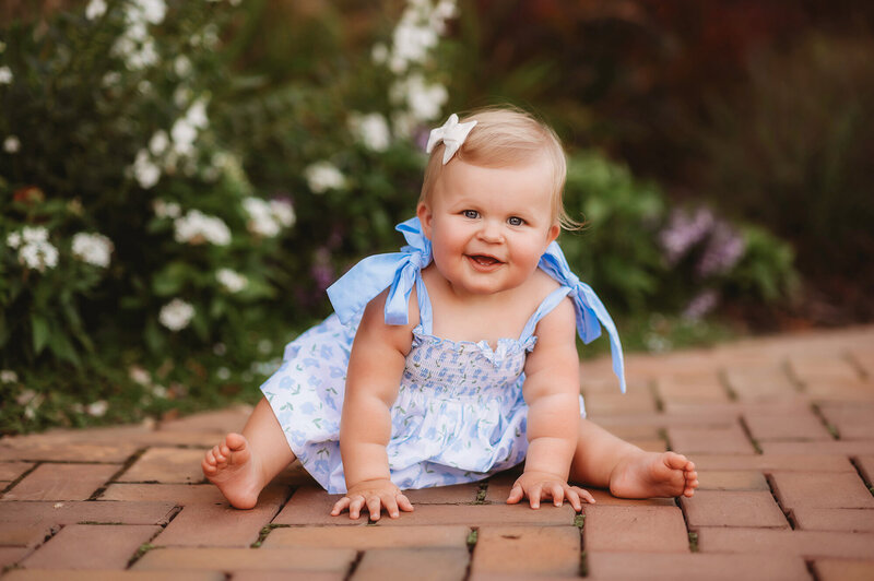 Baby grins at the camera during Biltmore Estate Family Photos in Asheville, NC.