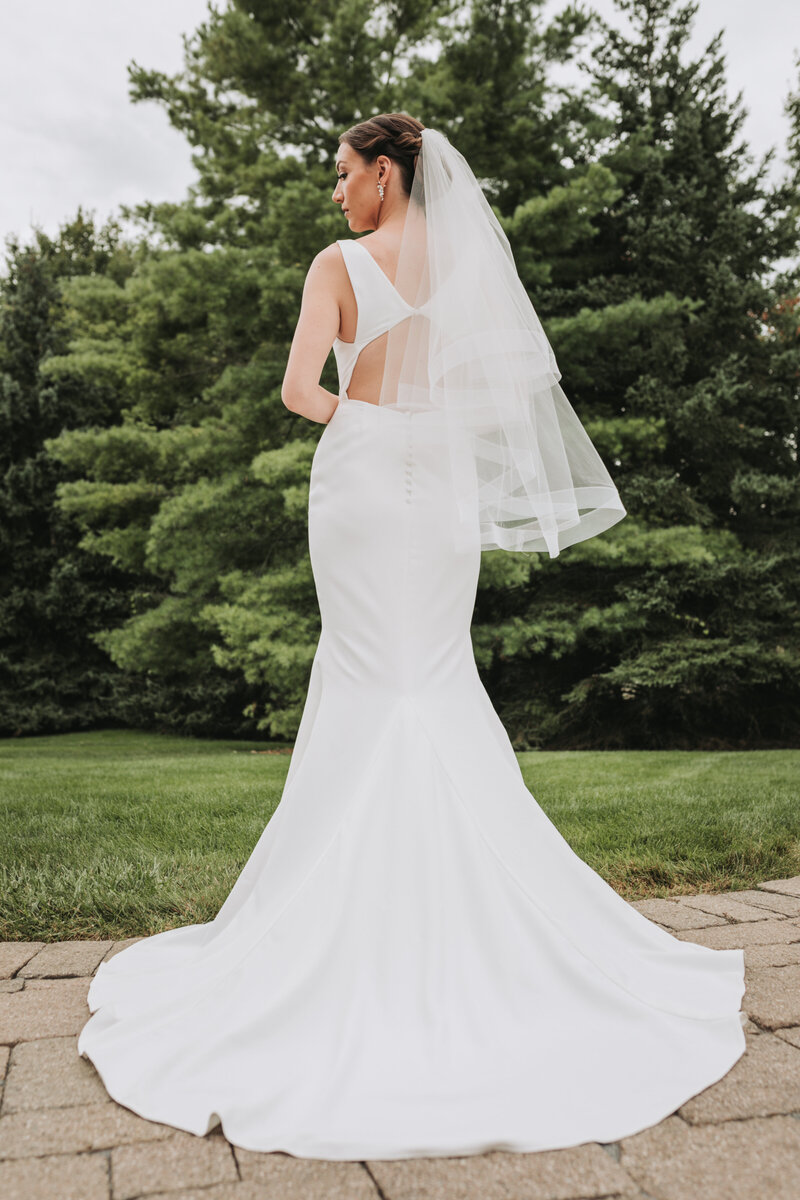 Portrait of the back of the brides wedding gown
