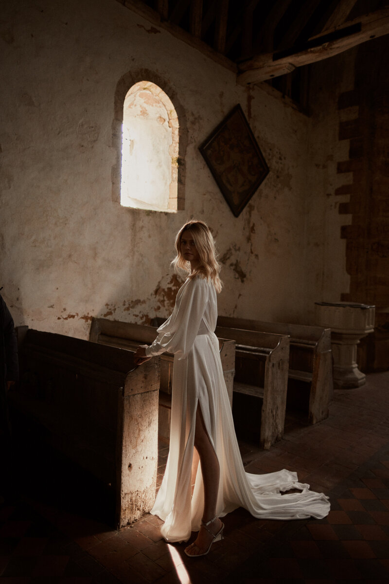 Deep v back silk wedding dress on bride in church