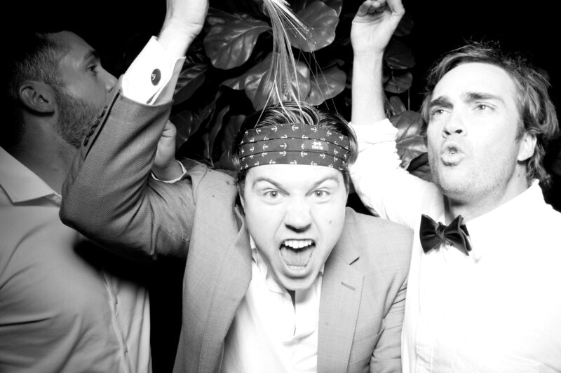 wedding guests smiling for roaming photo booth at reception