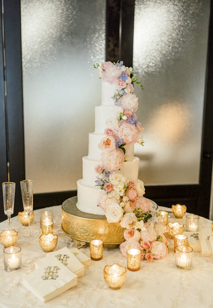 picture of a wedding cake with beautiful floral decorations and lots of candles