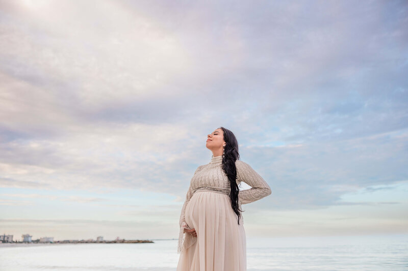 Couples takes photos in the ocean on the gulf coast of Florida