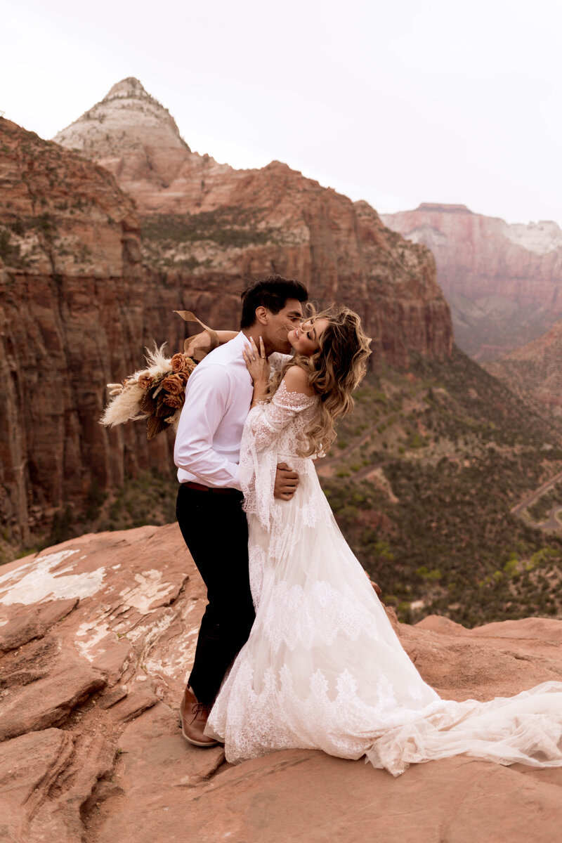 Couple holding each other in field