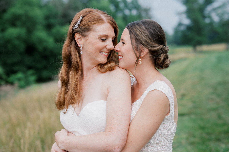 Two brides walking down the aisle at outdoor Philadelphia wedding