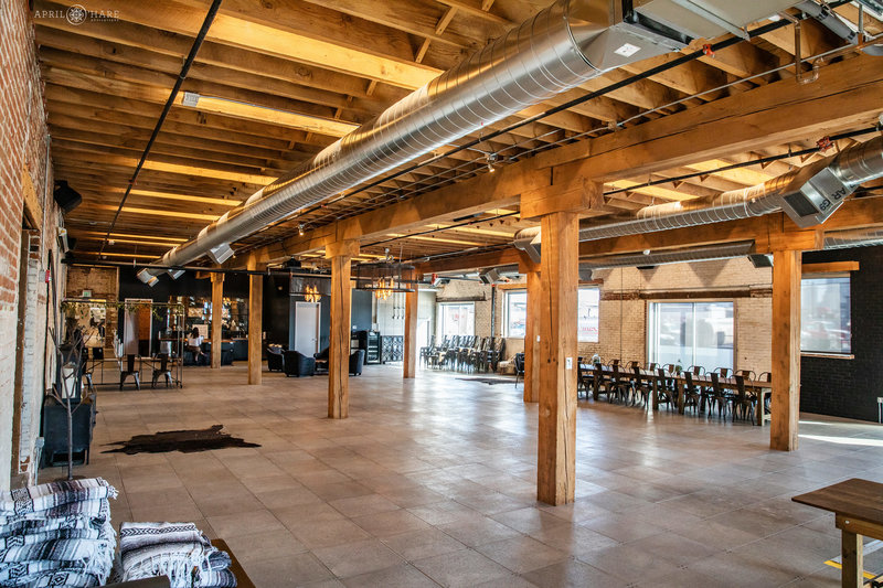 Exposed wood beams on the ceiling in large industrial wedding event space Shyft