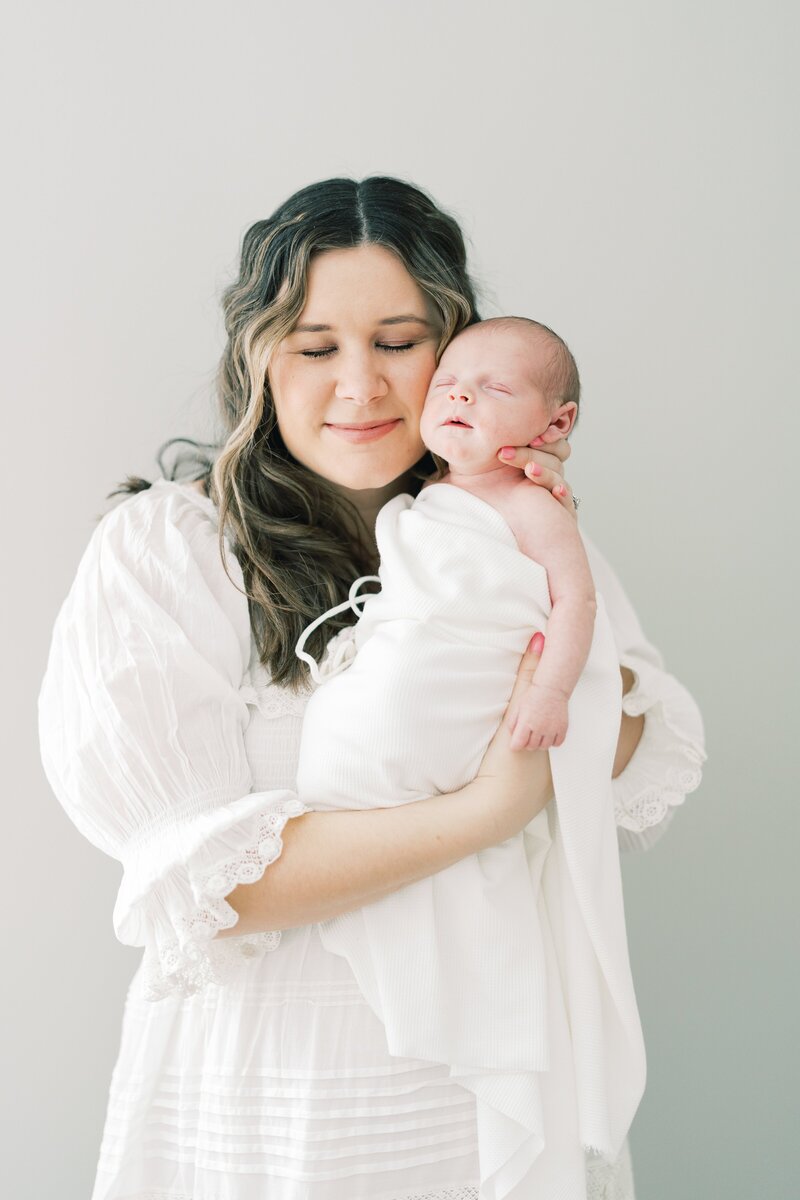 A sweet moment of a mom and her baby during a Dallas at home newborn session.