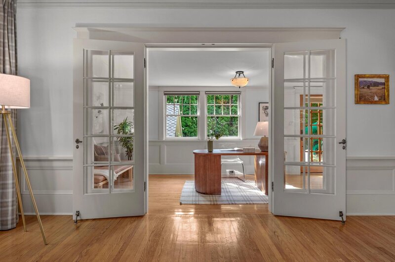 A look through open french doors into a home office.