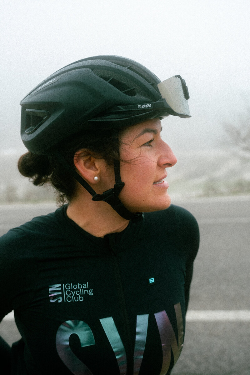 Female Cyclist Overlooking the Mountains in the Dolomites, Italy