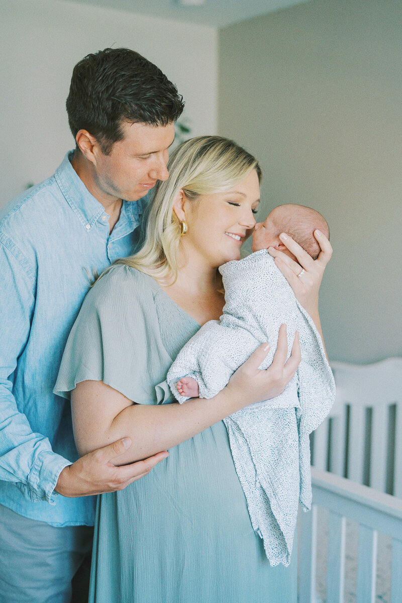 parents smiling at their newborn baby