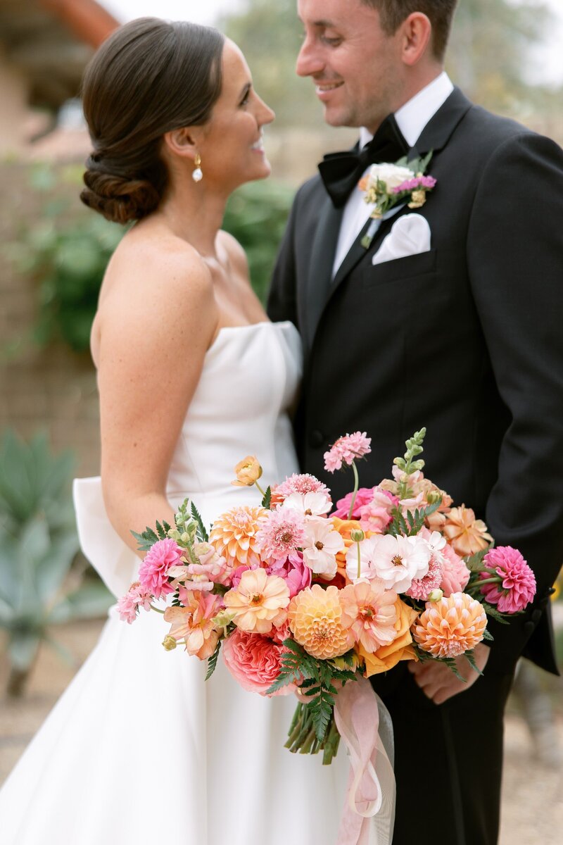 Bride and groom stand forehead to forehead outdoors in Ojai