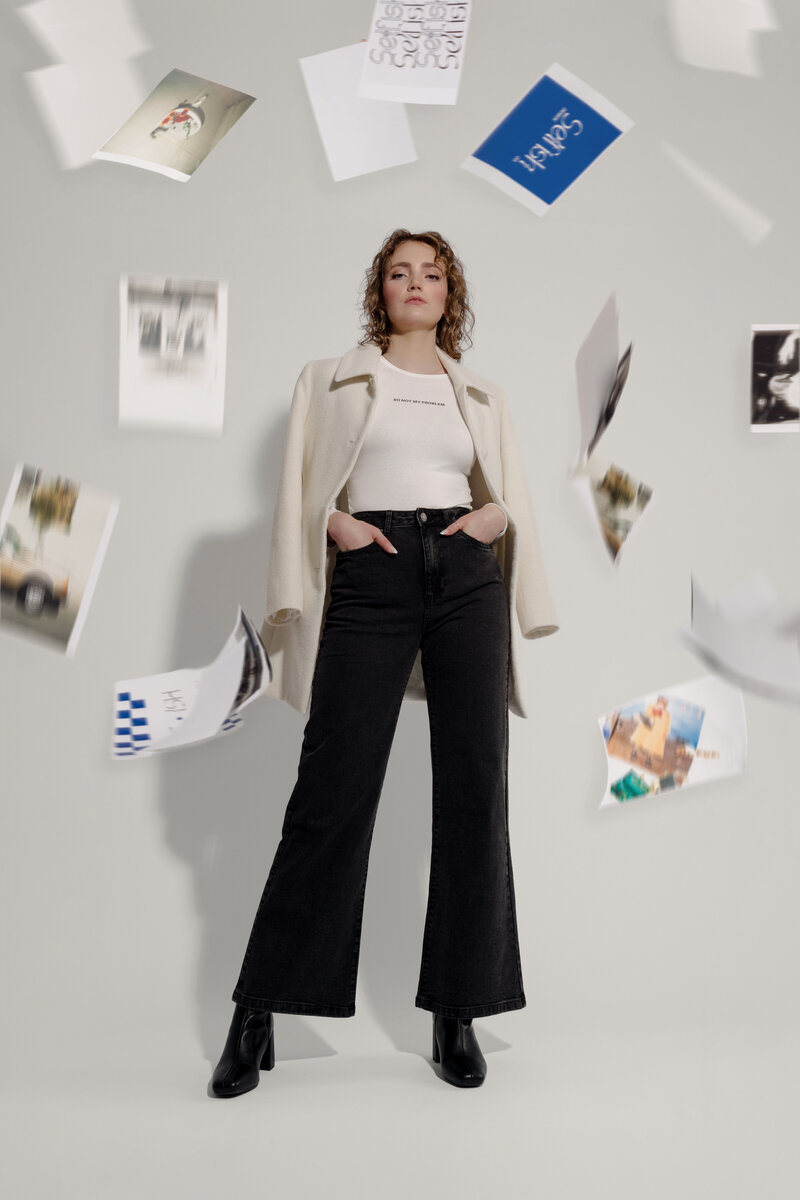 Woman standing with hands in pockets