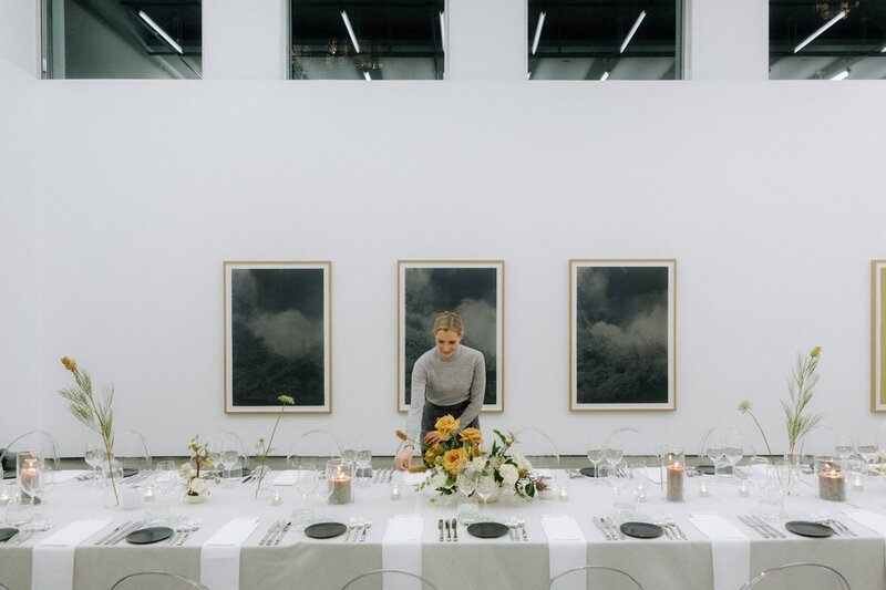 smitten events planner preparing reception for their clients at the contemporary art gallery