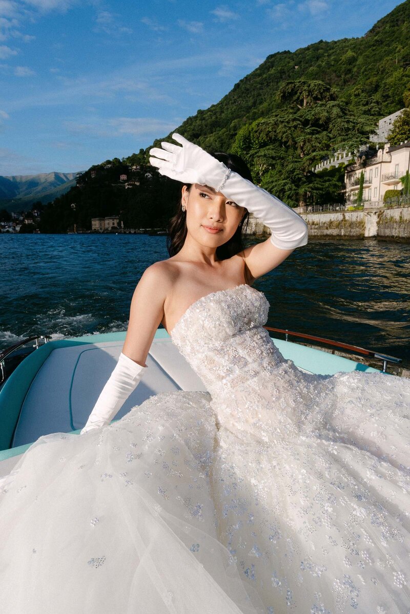 Bride posing on a riva boat outside villa Passalacqua in Lake Como Italy.