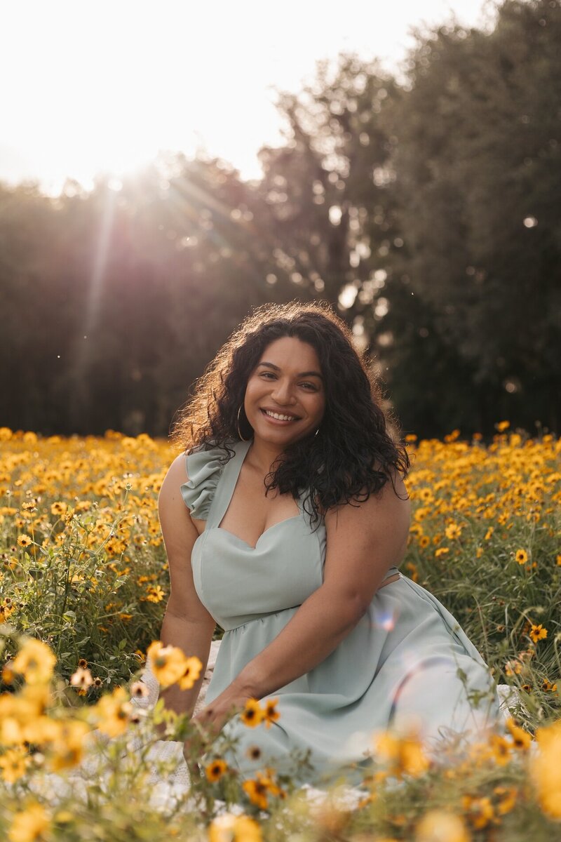 gainesville fl photographer dani of Indie West Photo brand photo sitting in field of flowers