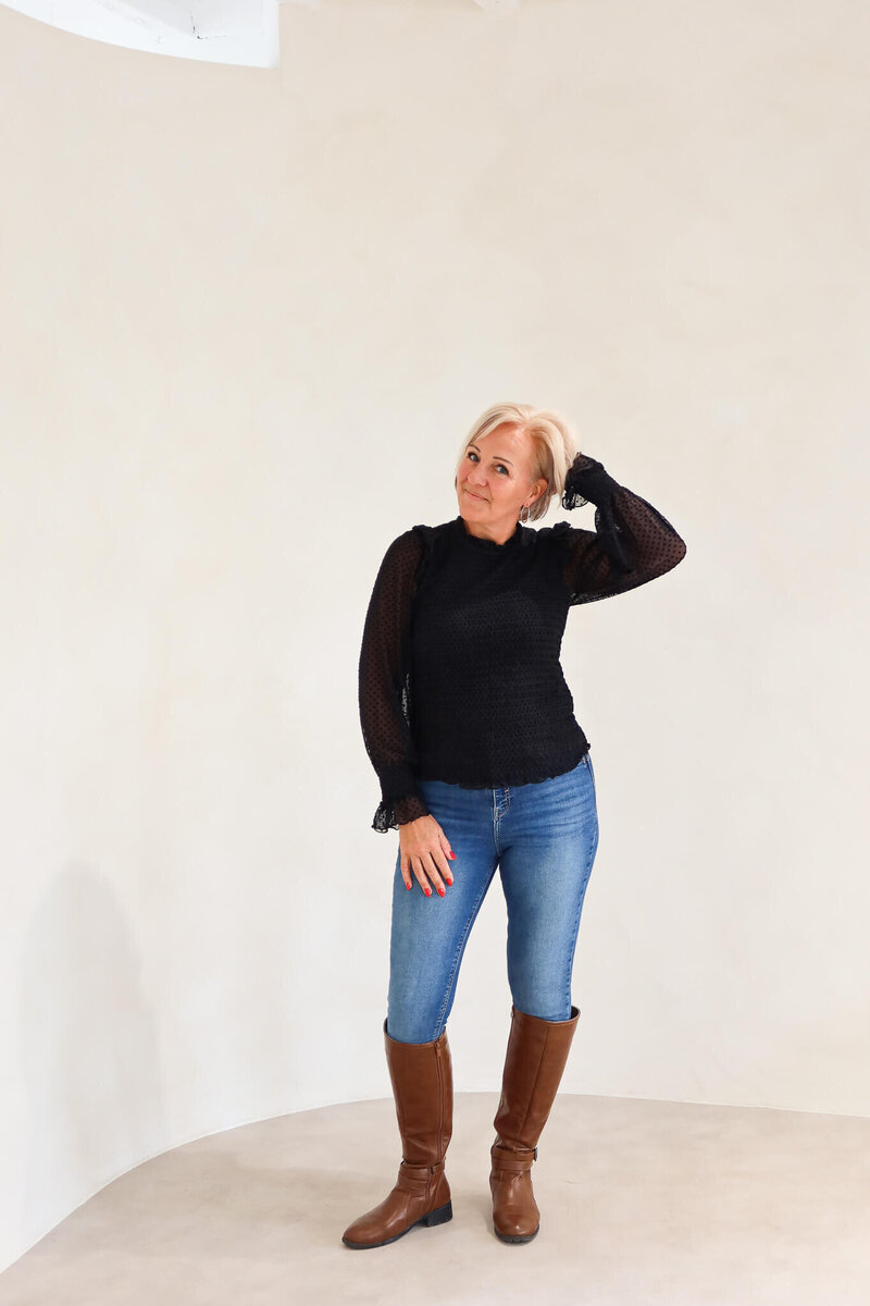 Sober coach for women in midlife, Sharron from Midlife Sober Glow, standing confidently against a neutral backdrop.
