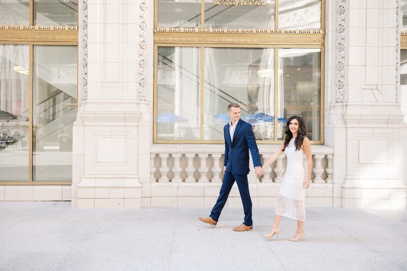 Engaged couple walking in downtown Chicago for their photos by Chicago wedding photographer Winterlyn Stebner