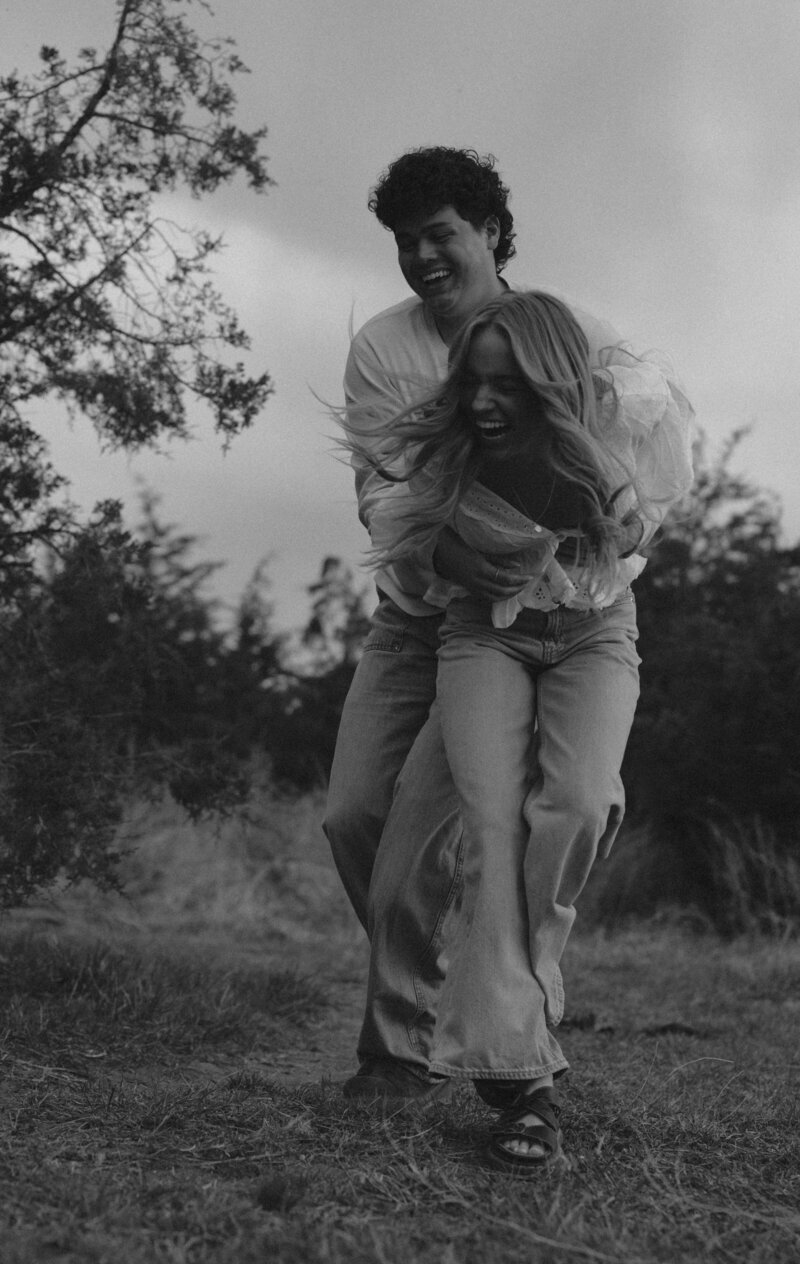 Close up black and white photo of a couple that's about to kiss.