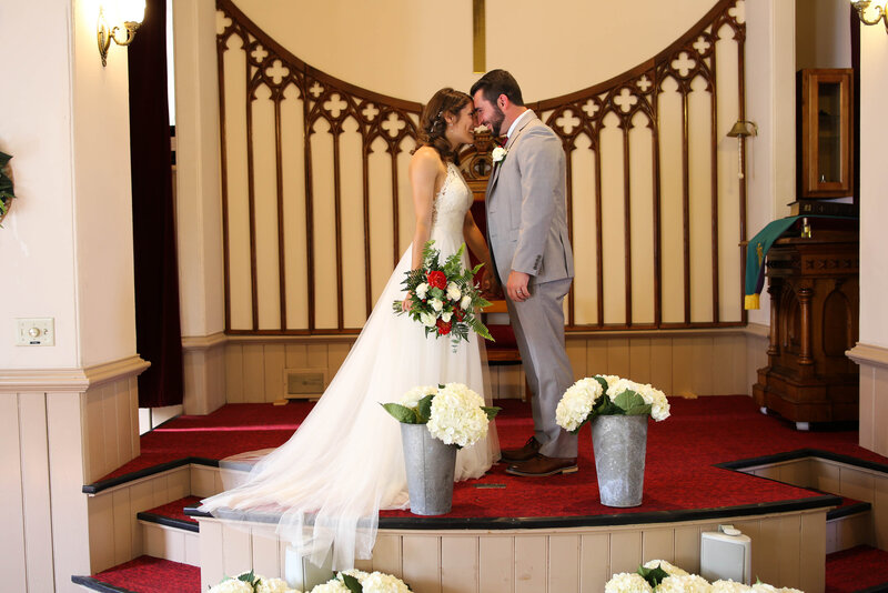 Bride and Groom with heads together at altar | Acadia Wedding