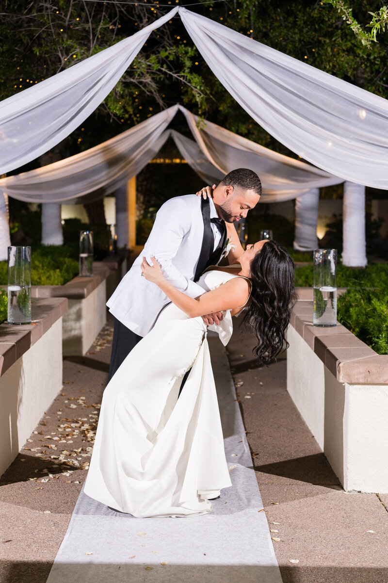 Bride and groom sharing a romantic moment by the pond at Emerald at Queensridge.