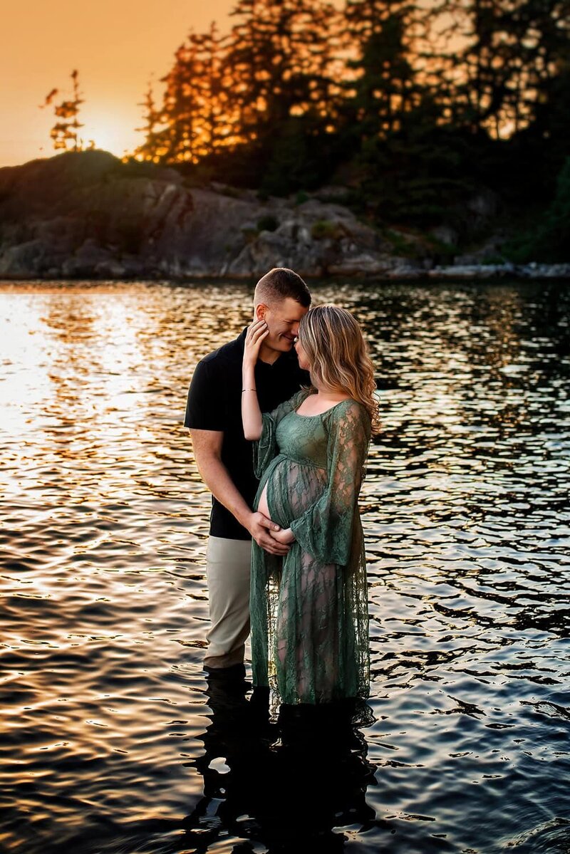 Expecting couple in the water at Whytecliff Park in West Vancouver during a romantic sunset outdoor maternity photoshoot.