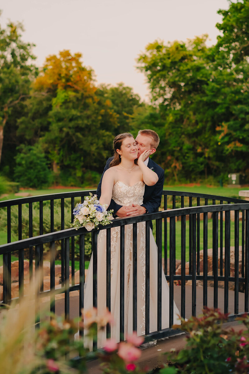 groom kissing bride at wedding in oklahoma